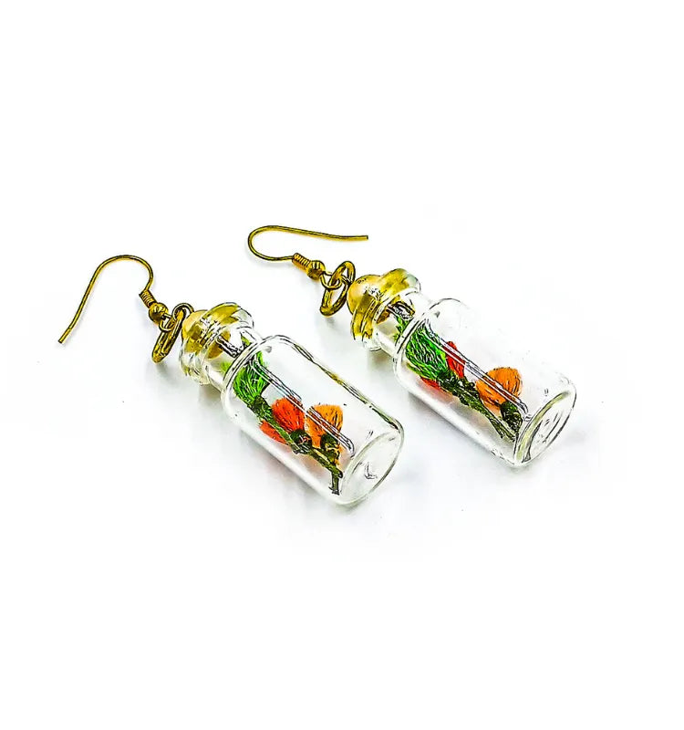Woman wearing quirky mini glass bottle earrings – bohemian glass jewelry India