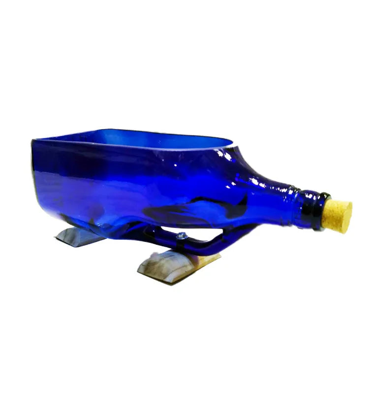 Money plant roots growing in antiquity blue glass bottle planter