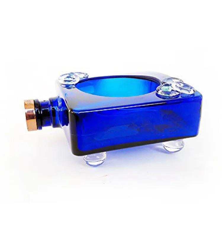 Handcrafted cobalt blue bottle planter holding pothos plant on a living room shelf