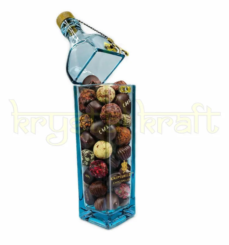 Handmade upcycled blue label glass bottle canister with cork lid used for candy storage and eco-friendly home decor in India.