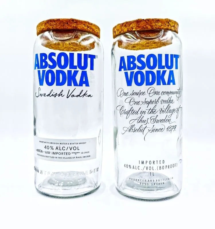 Pair of upcycled Absolut jars with sleek polished glass and original branding, ideal for storing snacks or displaying flowers in eco-luxury interiors.