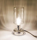 Elegant recycled bottle lamp creating warm ambient lighting for eco-conscious homes