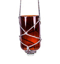 Artistic upcycled glass bottle planter hanging in living room, showcasing eco-friendly home decoration.