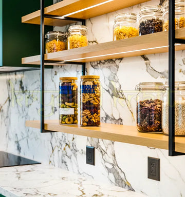 Set of two upcycled Absolut bottle jars handcrafted from original bottles, featuring polished finish and vibrant branding—perfect for eco-friendly decor or storage.