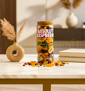 Handcrafted upcycled Absolut Raspberri jar featuring the iconic pink bottle design and smooth finish, perfect for eco-friendly home decor or gifting.
