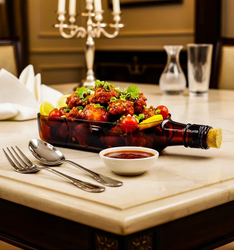 A handcrafted upcycled Ballantine bottle serving platter with a polished finish, perfect for serving cheese, snacks, and appetizers in sustainable style.