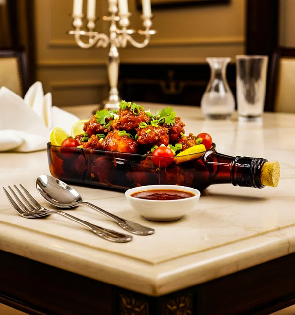 A handcrafted upcycled Ballantine bottle serving platter with a polished finish, perfect for serving cheese, snacks, and appetizers in sustainable style.