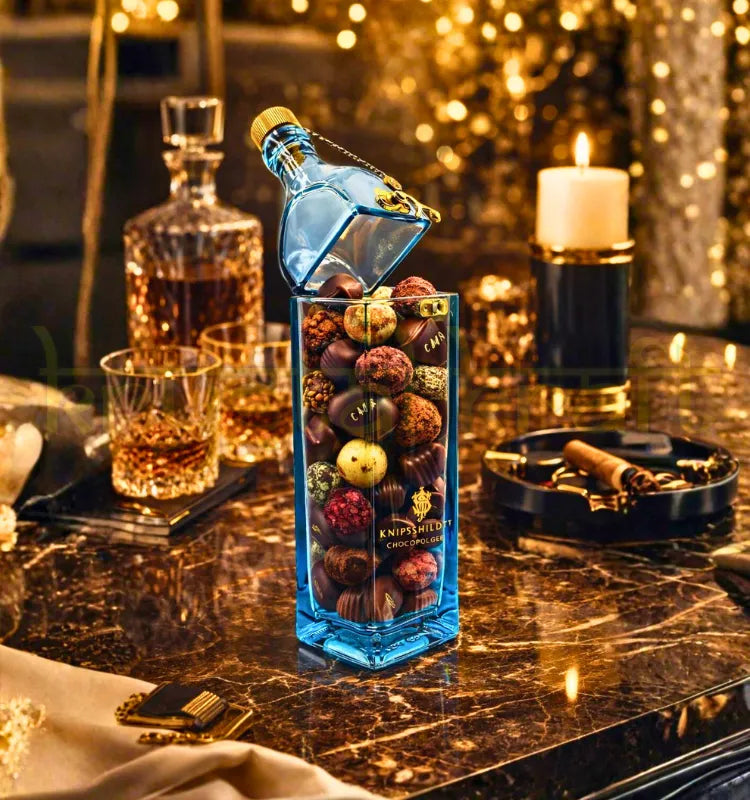 Handmade upcycled blue label glass bottle canister with cork lid used for candy storage and eco-friendly home decor in India.