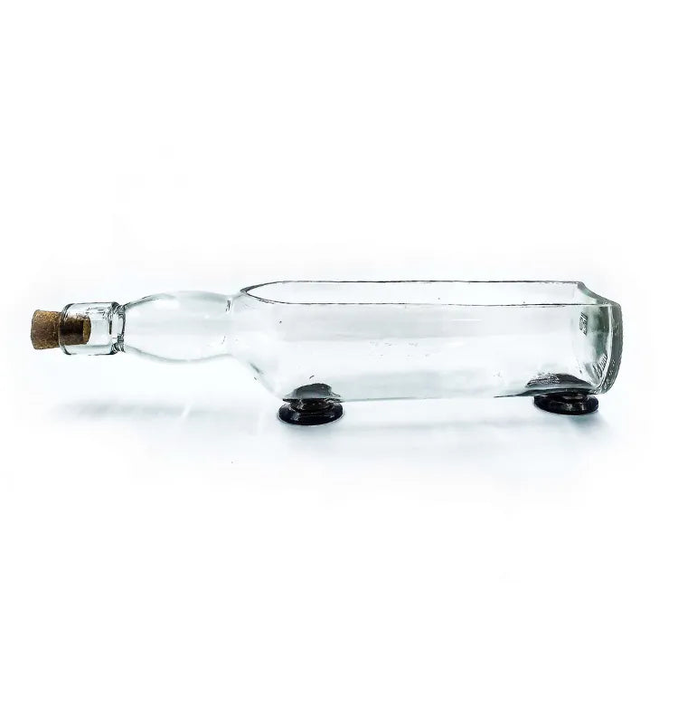 Glenlivet white bottle planter styled with green plant on office desk as upcycled home décor