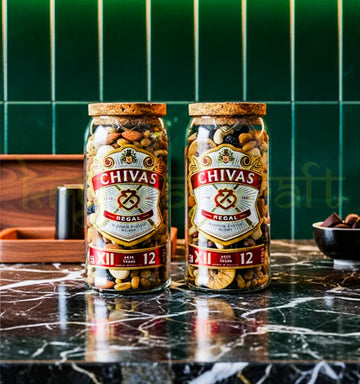 Set of two upcycled Chivas Regal jars handcrafted from original bottles, featuring preserved branding and sleek finish—perfect for eco-luxury home decor.