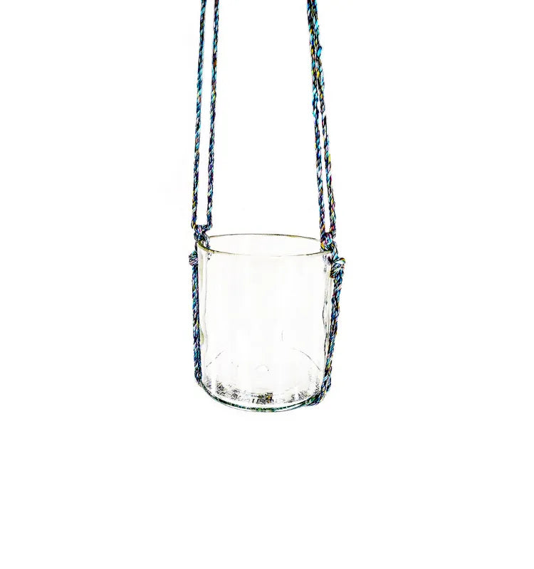 Elegant Krystal Kraft glass hanging planter with upcycled bottle design, holding a vibrant green plant in a modern living room.