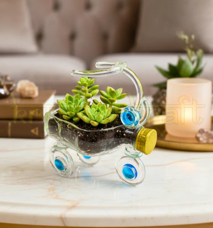 Upcycled glass tricycle planter handcrafted by artist Raees Ahmed Merchant — made from repurposed glass bottles with blue and gold accents, ideal as a sustainable home or office décor piece or indoor planter.