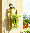 A handcrafted hanging wall planter made from an upcycled Greater Than Gin bottle, mounted on a sleek frame — perfect for growing succulents, herbs, or indoor plants with sustainable style.