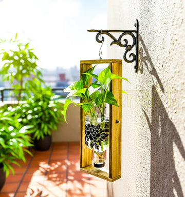 A handcrafted hanging wall planter made from an upcycled Greater Than Gin bottle with elegant floral print, mounted on a wooden frame — perfect for indoor or balcony greenery.