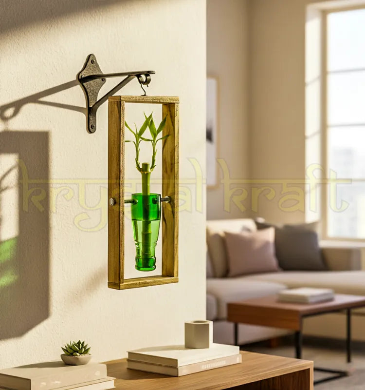 An elegant hanging wall planter handcrafted from an upcycled green neck glass bottle mounted on a rustic frame — perfect for indoor plants, balcony gardens, and eco-friendly home decor.