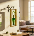 An elegant hanging wall planter handcrafted from an upcycled green neck glass bottle mounted on a rustic frame — perfect for indoor plants, balcony gardens, and eco-friendly home decor.