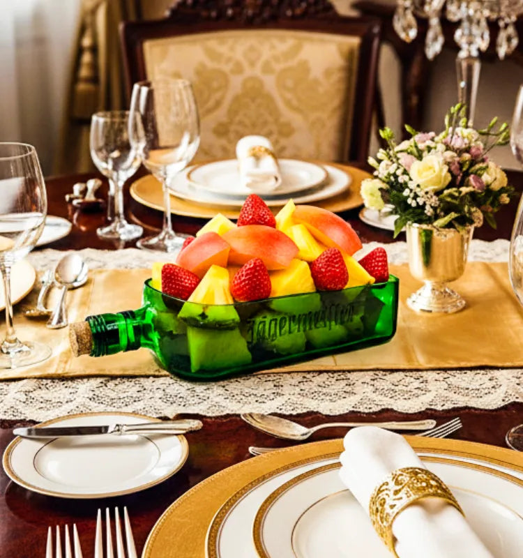 A handcrafted serving platter made from an authentic Jägermeister bottle, featuring its signature green color and logo, ideal for serving snacks and appetizers sustainably.