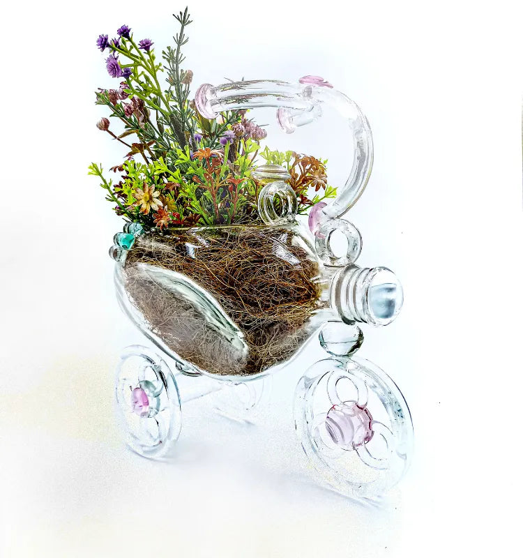 Handmade upcycled glass tricycle planter by Raees Ahmed Merchant, clear with pink accents, eco-friendly home décor