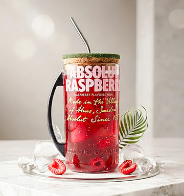 Upcycled Absolut Raspberri glass bottle mug with clear sipper lid, front view on white