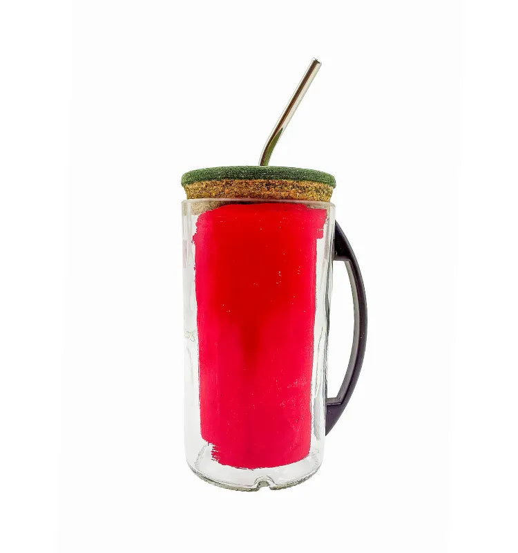 Hand holding upcycled Absolut glass sipper mug with iced drink, sustainable reusable tumbler