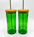 Eco-friendly upcycled glass sipper filled with water on a wooden desk