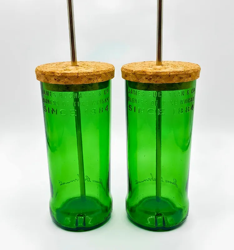 Eco-friendly upcycled glass sipper filled with water on a wooden desk