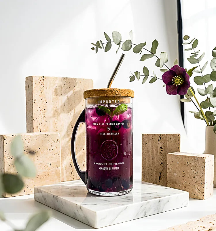 Upcycled Ciroc bottle sipper mug with metal handle in eco-friendly setting